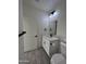 Clean bathroom, featuring a white vanity, toilet and gray floor tile at 8306 W Swansea Dr, Arizona City, AZ 85123