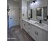 Modern bathroom with double vanity, large mirror, and grey tile at 8306 W Swansea Dr, Arizona City, AZ 85123