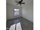 Spacious bedroom with gray wood-look tile floors and large window at 8306 W Swansea Dr, Arizona City, AZ 85123