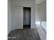 Bright bedroom closet with shelving and gray wood-look tile floors at 8306 W Swansea Dr, Arizona City, AZ 85123