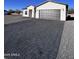 House exterior showcasing a paved driveway and modern design at 8306 W Swansea Dr, Arizona City, AZ 85123