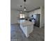 Bright kitchen featuring an island and white cabinets at 8306 W Swansea Dr, Arizona City, AZ 85123