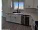 White kitchen with double sink and stainless steel dishwasher at 8306 W Swansea Dr, Arizona City, AZ 85123