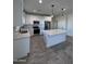 Modern kitchen with white cabinets and large island at 8306 W Swansea Dr, Arizona City, AZ 85123