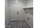 Laundry room with door, shelving, and gray floor tile at 8306 W Swansea Dr, Arizona City, AZ 85123