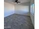 Spacious living room with ceiling fan and large window at 8306 W Swansea Dr, Arizona City, AZ 85123