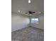 Bright living room featuring gray wood-look tile floors and a ceiling fan at 8306 W Swansea Dr, Arizona City, AZ 85123