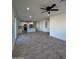 Open living room with kitchen view and grey tile floor at 8306 W Swansea Dr, Arizona City, AZ 85123