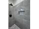 Updated shower with gray tile and mosaic accent at 8306 W Swansea Dr, Arizona City, AZ 85123