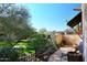 Landscaped backyard with grassy area and mature trees at 8911 E Rusty Spur Pl, Scottsdale, AZ 85255