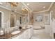 Elegant bathroom with double vanity, soaking tub, and large mirror at 8911 E Rusty Spur Pl, Scottsdale, AZ 85255