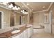 Bathroom with double vanity, soaking tub, and granite countertop at 8911 E Rusty Spur Pl, Scottsdale, AZ 85255