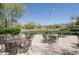 Outdoor patio area with tables, chairs, and string lights at 8911 E Rusty Spur Pl, Scottsdale, AZ 85255