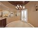 Elegant dining room with a chandelier and access to a patio at 8911 E Rusty Spur Pl, Scottsdale, AZ 85255