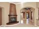 Elegant corner fireplace with dark wood mantel and decorative finish at 8911 E Rusty Spur Pl, Scottsdale, AZ 85255