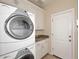 Convenient laundry room with stacked washer and dryer at 8911 E Rusty Spur Pl, Scottsdale, AZ 85255