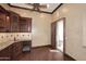 Wet bar with wood cabinetry, granite countertops, and wine cooler at 8911 E Rusty Spur Pl, Scottsdale, AZ 85255