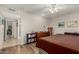 Cozy bedroom with hardwood floors, a bookshelf, and a view of the hallway at 9403 W Fern Dr, Sun City, AZ 85351