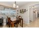 Dining area features wooden table, chairs, and window views at 9403 W Fern Dr, Sun City, AZ 85351