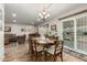 Bright dining area with wood floors and sliding glass door access to backyard at 9403 W Fern Dr, Sun City, AZ 85351