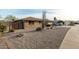 Ranch style home with rock landscaping and a two-car garage at 9403 W Fern Dr, Sun City, AZ 85351