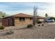 Brick ranch house with a two-car garage and desert landscaping at 9403 W Fern Dr, Sun City, AZ 85351