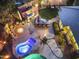 Night aerial view showcasing outdoor kitchen, fire pit, pool and lush landscaping at 953 E Fieldstone Pl, Chandler, AZ 85249