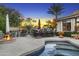 Inviting backyard with an outdoor kitchen, dining space, lush greenery, and a relaxing pool at 953 E Fieldstone Pl, Chandler, AZ 85249