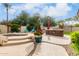 A cozy outdoor living space complete with a outdoor kitchen, pool and manicured landscape at 953 E Fieldstone Pl, Chandler, AZ 85249