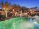 Beautiful backyard pool with spa, rock waterfall, and lush landscaping creating a tranquil and inviting outdoor space at 953 E Fieldstone Pl, Chandler, AZ 85249