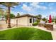 Backyard view of the home, featuring turf, a grill and lush landscaping at 953 E Fieldstone Pl, Chandler, AZ 85249