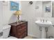 Powder room with pedestal sink and decorative mirror at 953 E Fieldstone Pl, Chandler, AZ 85249