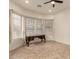 Neutral bedroom featuring tile floors, multiple windows with blinds, and a dark wood desk at 953 E Fieldstone Pl, Chandler, AZ 85249