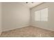 Minimalist bedroom featuring neutral walls, tile floors, and a window with bright natural light at 953 E Fieldstone Pl, Chandler, AZ 85249