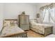 Cozy bedroom featuring two twin beds and a charming wooden cabinet with floral patterned bedspreads at 953 E Fieldstone Pl, Chandler, AZ 85249