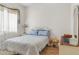 Bright bedroom featuring a comfortable bed with blue accents, white furniture, and light-filled ambiance at 953 E Fieldstone Pl, Chandler, AZ 85249