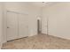 Bright bedroom featuring tile floors, white walls and trim, closet, and doorways at 953 E Fieldstone Pl, Chandler, AZ 85249