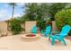 Backyard firepit surrounded by cozy seating offers the perfect spot for outdoor relaxation at 953 E Fieldstone Pl, Chandler, AZ 85249