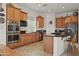 Well-equipped kitchen with stainless steel appliances, dark countertops, and ample cabinet space at 953 E Fieldstone Pl, Chandler, AZ 85249