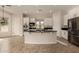 Bright kitchen features a large island with cooktop, black countertops, and white cabinetry at 953 E Fieldstone Pl, Chandler, AZ 85249