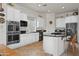 Bright kitchen featuring white cabinets, stainless steel appliances, and a center island with a breakfast bar at 953 E Fieldstone Pl, Chandler, AZ 85249