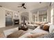 Cozy living room showcasing a fireplace, large sofa, and neutral decor at 953 E Fieldstone Pl, Chandler, AZ 85249