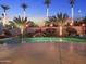 Inviting pool with a rock waterfall feature and lush landscaping, creating a serene backyard retreat at 953 E Fieldstone Pl, Chandler, AZ 85249