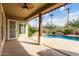 Covered outdoor patio that features a luxurious pool and lush landscaping for backyard enjoyment at 953 E Fieldstone Pl, Chandler, AZ 85249