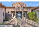 Inviting front exterior with stone accents and a modern entryway at 9740 E Lofty Point Rd, Scottsdale, AZ 85262