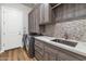 Laundry room with modern cabinets and large sink at 9740 E Lofty Point Rd, Scottsdale, AZ 85262