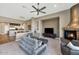 Living room with fireplace, seating area, and a large TV at 9740 E Lofty Point Rd, Scottsdale, AZ 85262