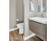 Modern powder room with floating vanity and wood-look tile at 9740 E Lofty Point Rd, Scottsdale, AZ 85262