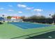 Community tennis court with green and blue surface at 10522 E Cinnabar Ave, Scottsdale, AZ 85258