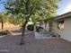 Covered patio with seating area, grill, and desert landscaping at 10840 E Keats Ave, Mesa, AZ 85209